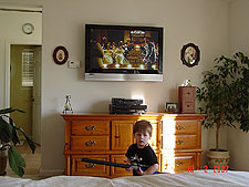 Hunter helps vacuum after mounting the TV